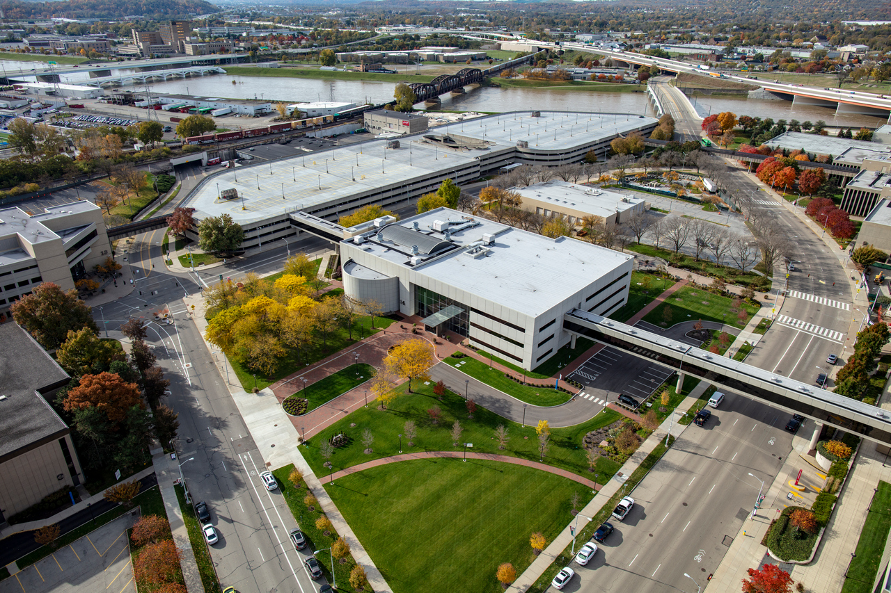 aerial photo of light colored stone buildng and yellow trees