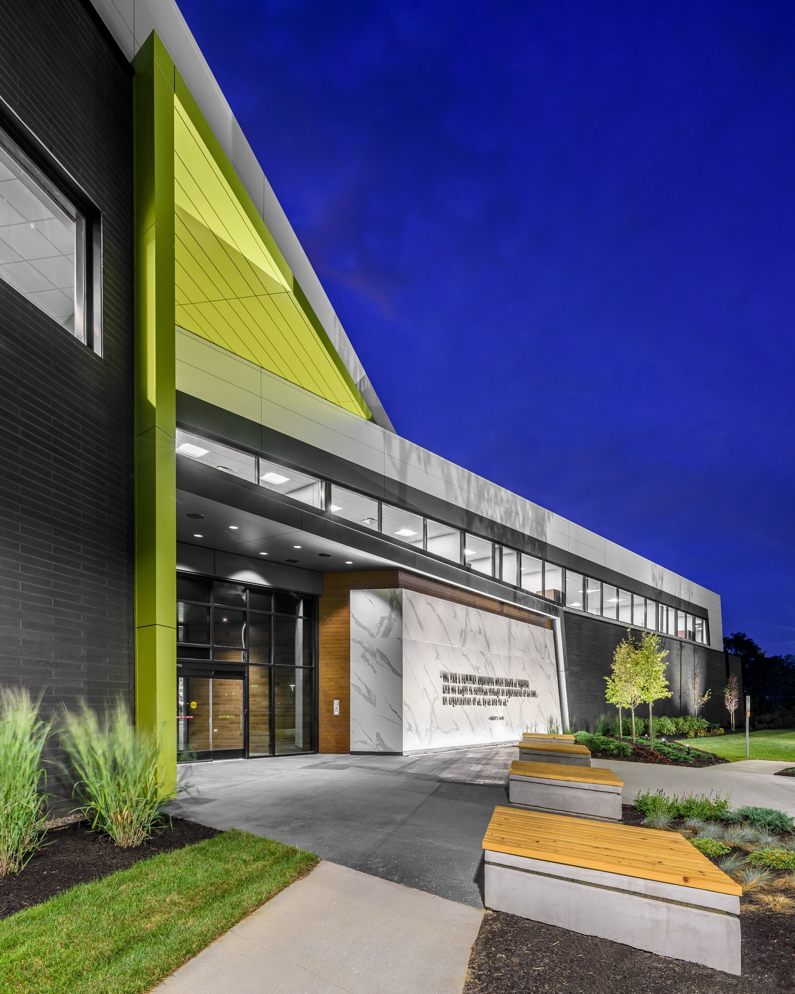 Office building at night with green neon lights and light up sign