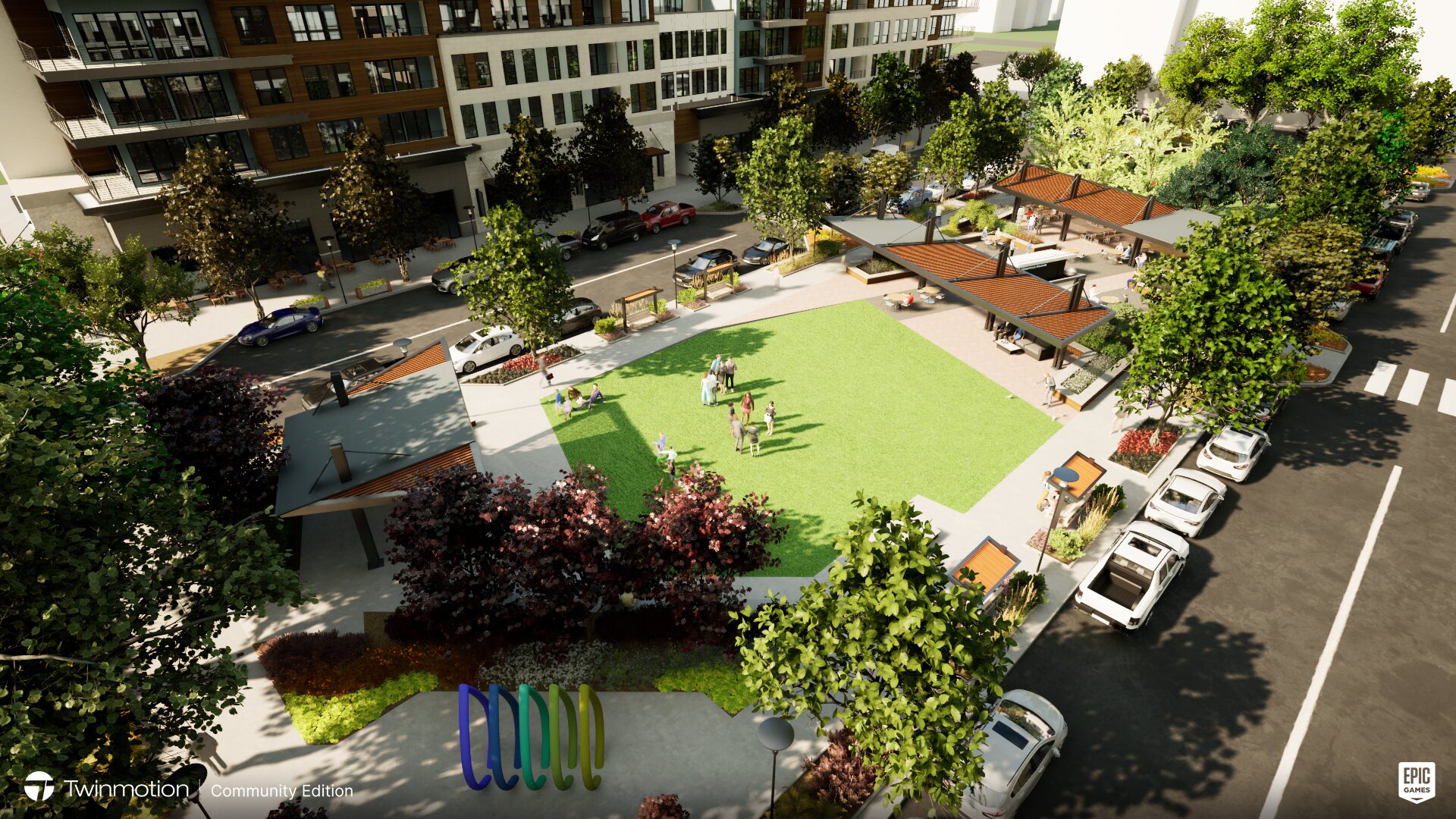 Urban park with grassy area, surrounded by trees and buildings.