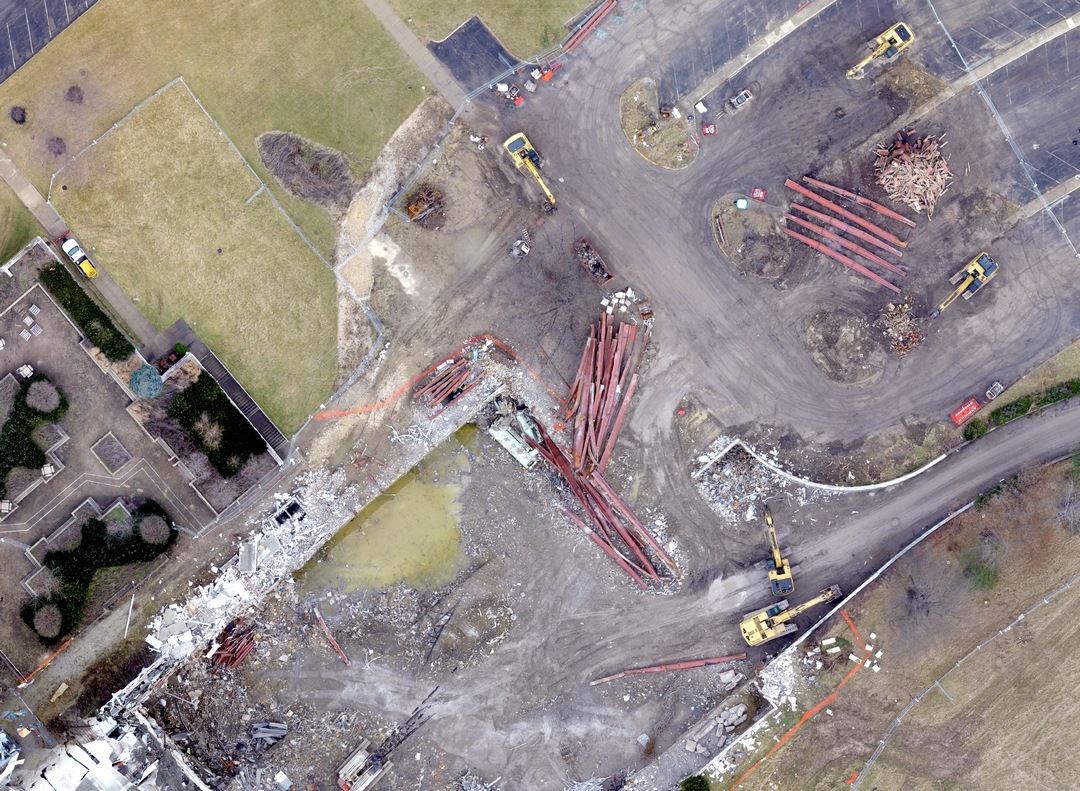 Aerial view of a construction site with machinery and scattered materials.