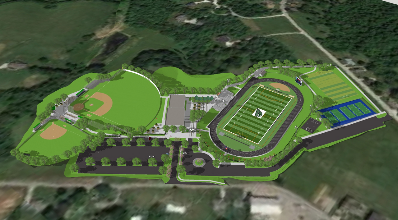 Aerial view of sports complex with fields, track, and parking.