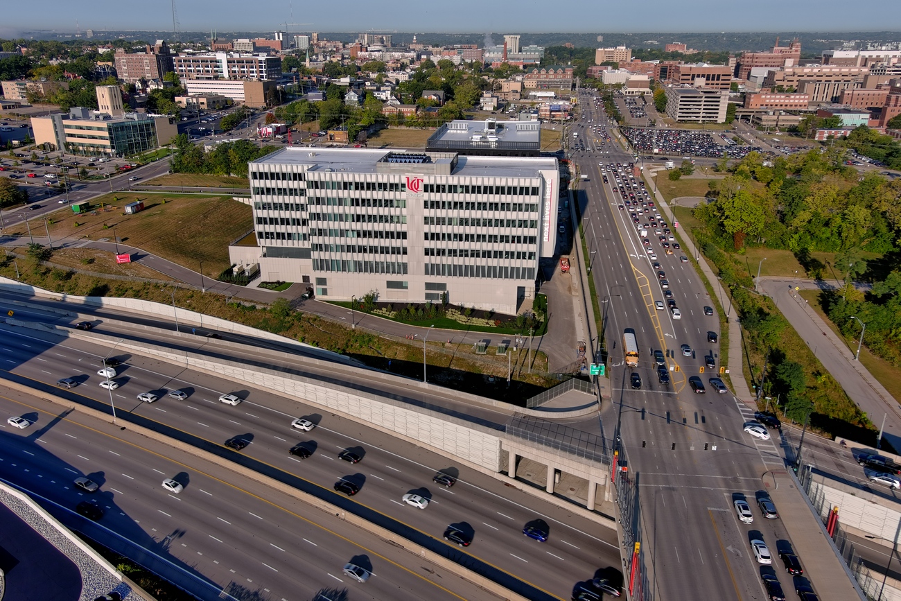 Aerial view of a busy highway near a large office building.