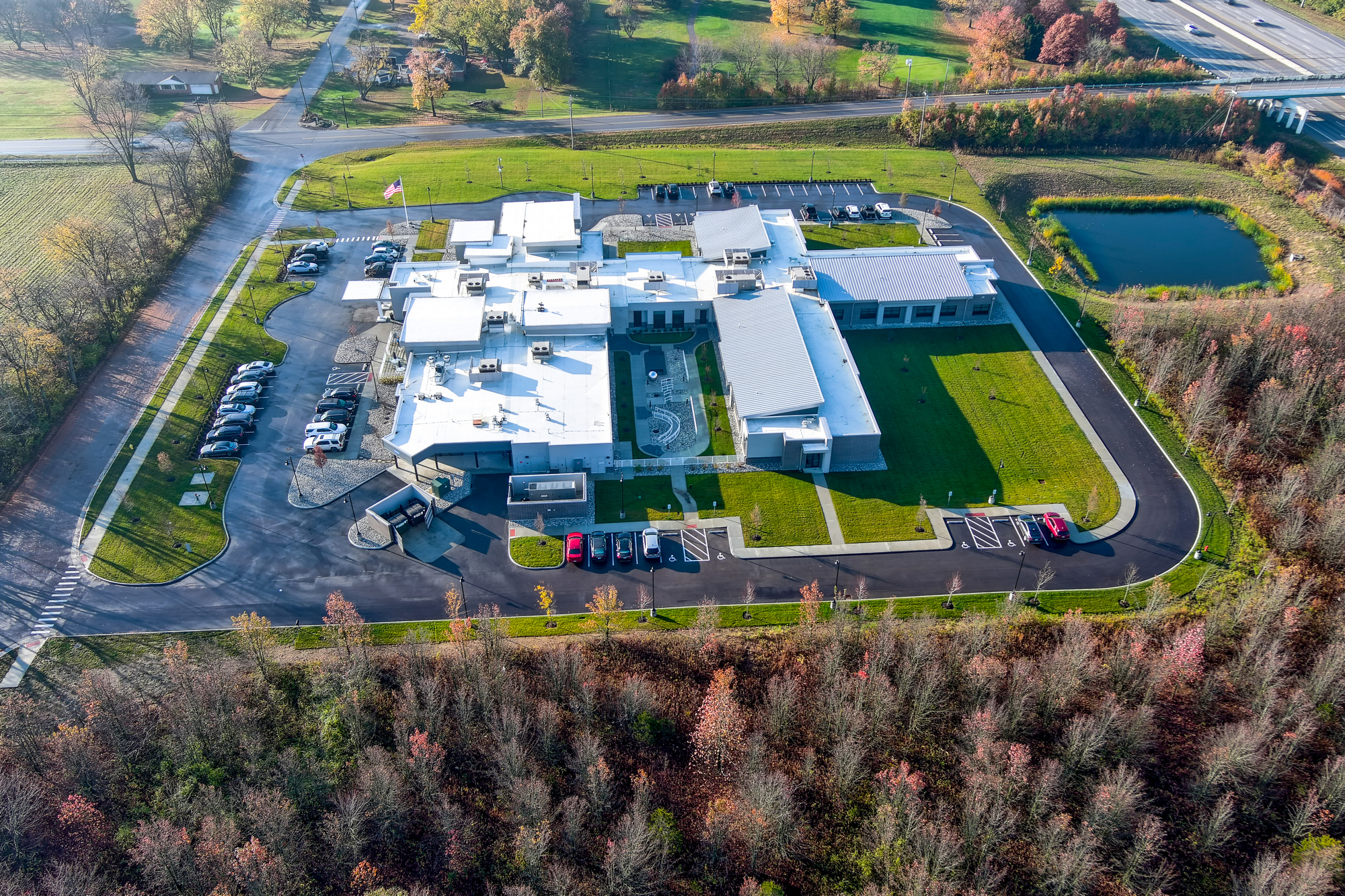 Aerial view of a large industrial complex with surrounding greenery.