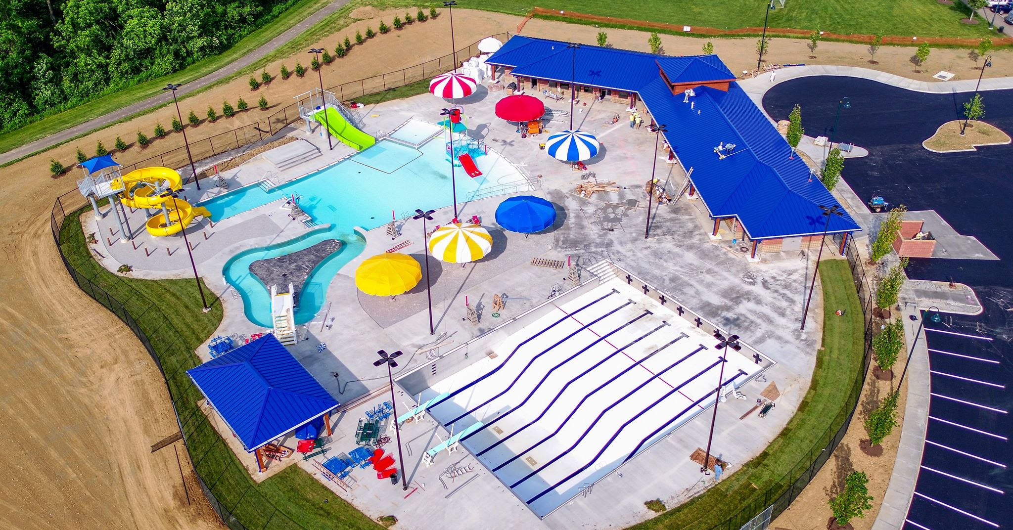 Aerial view of colorful water park with pools and umbrellas.