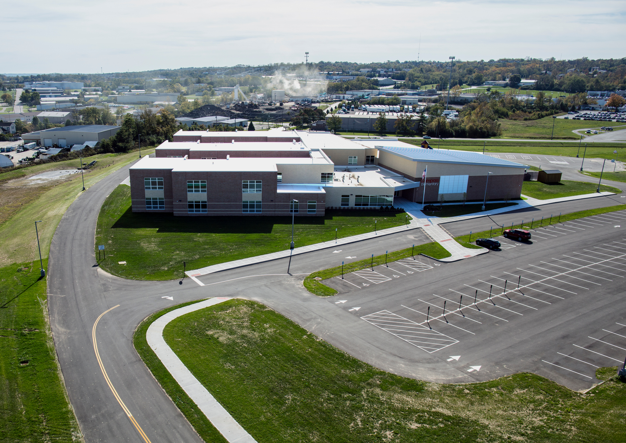 Aerial view of a school building with an empty parking lot.