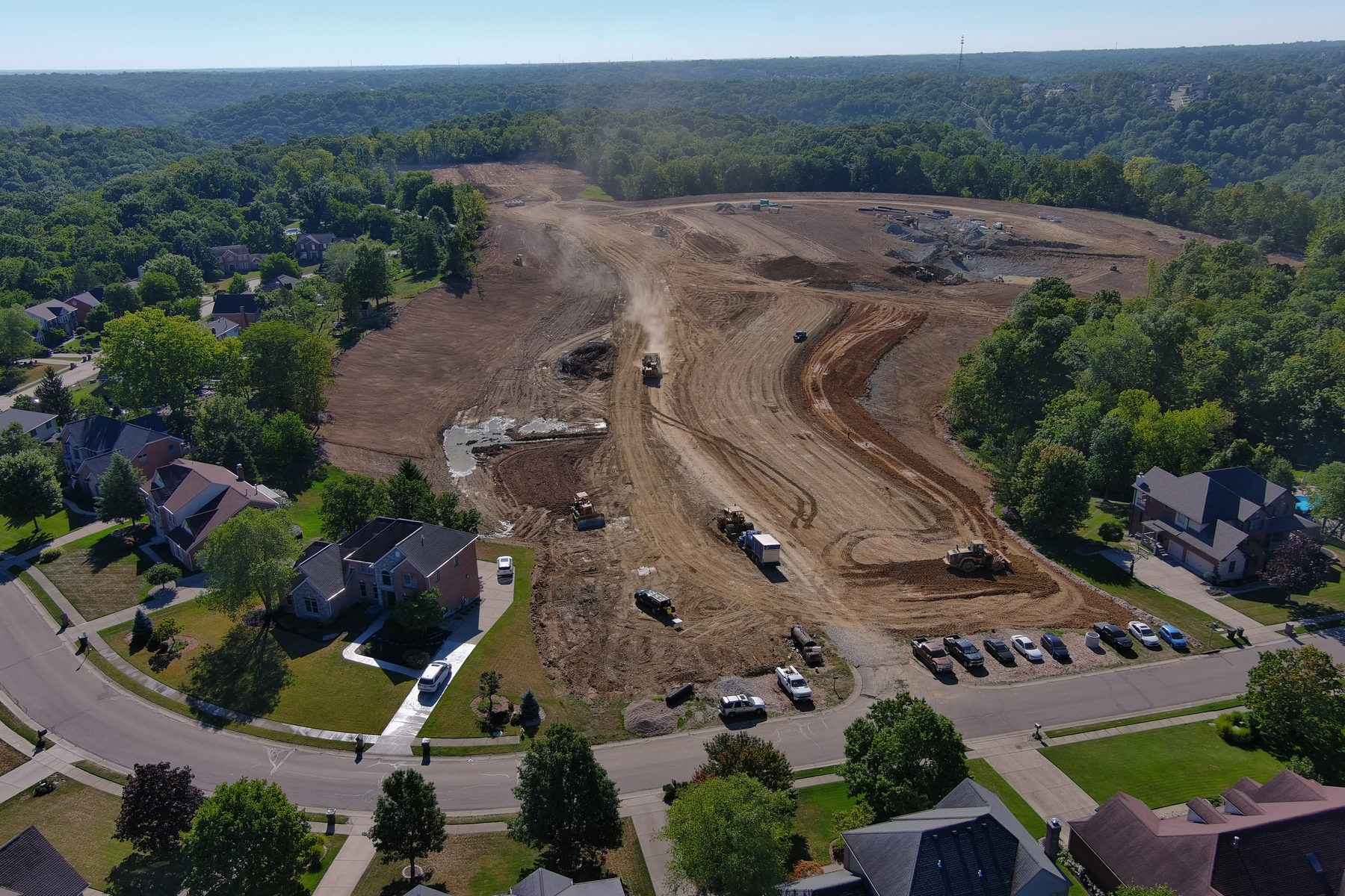 Aerial view of a large construction site near a residential area.