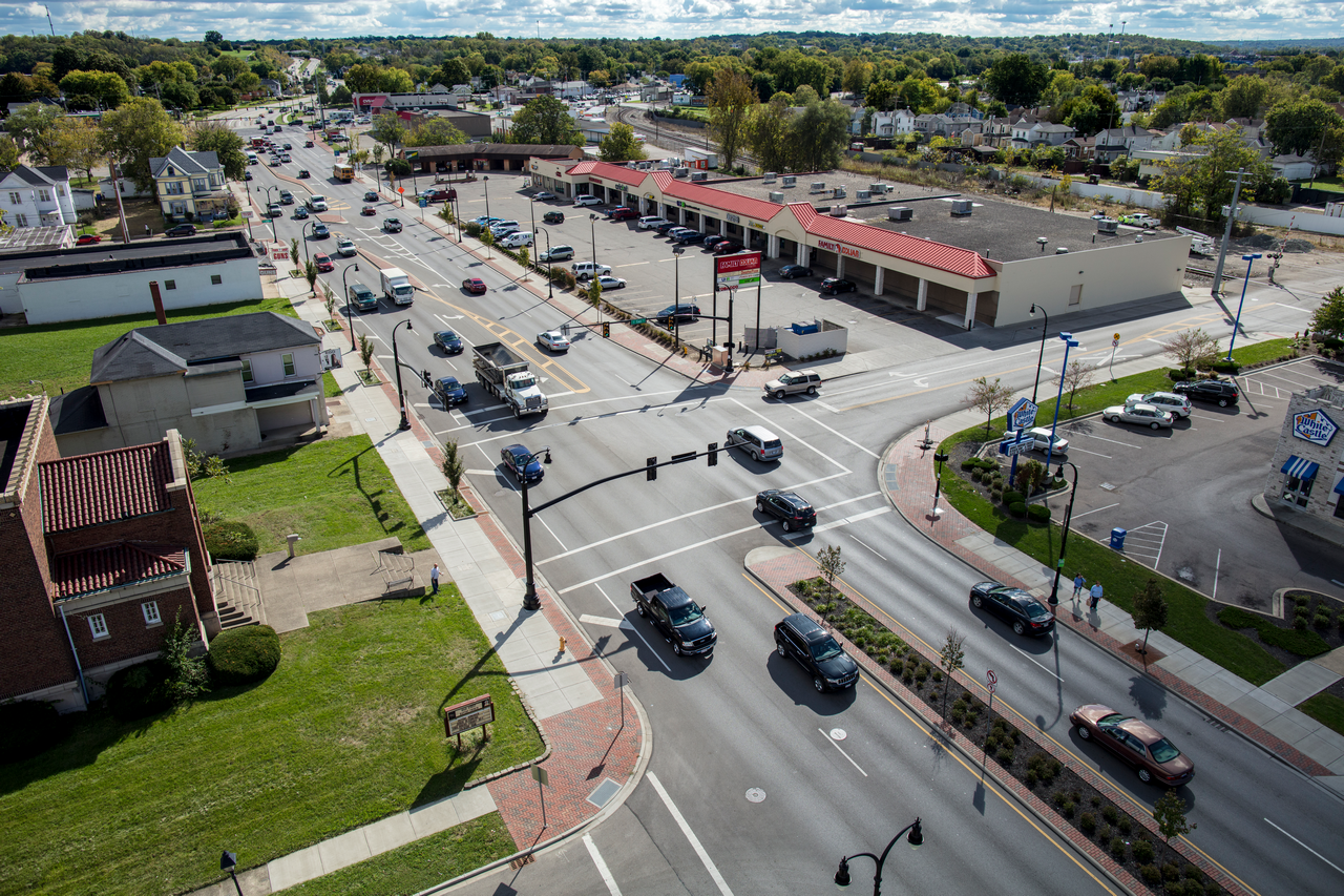 Aerial view of a busy intersection with cars and surrounding buildings.