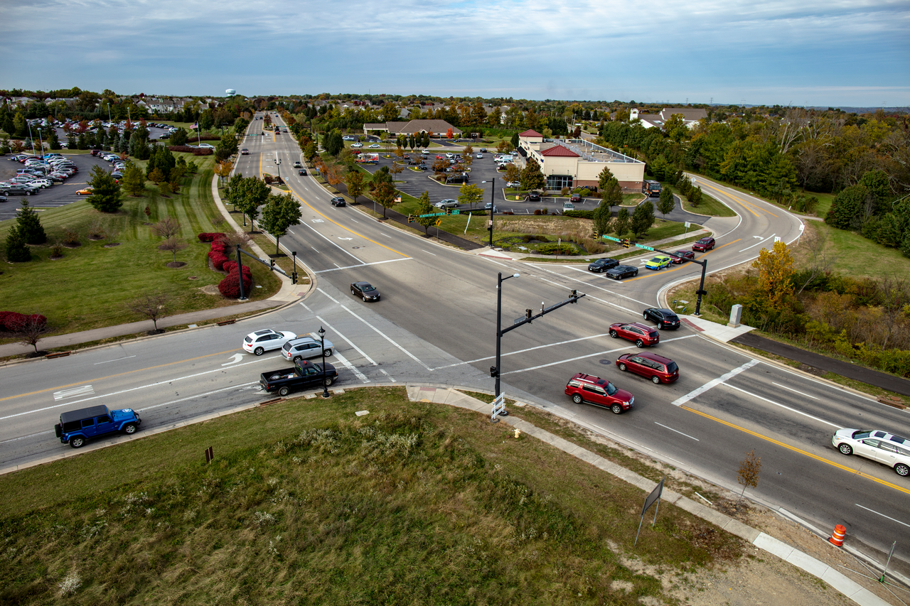 Aerial view of a busy road intersection in a suburban area.