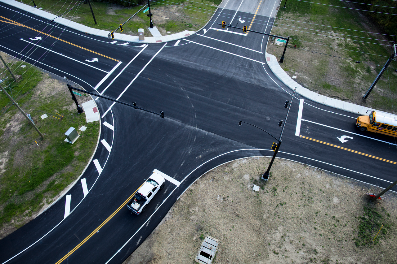 Aerial view of a four-way intersection with minimal traffic.