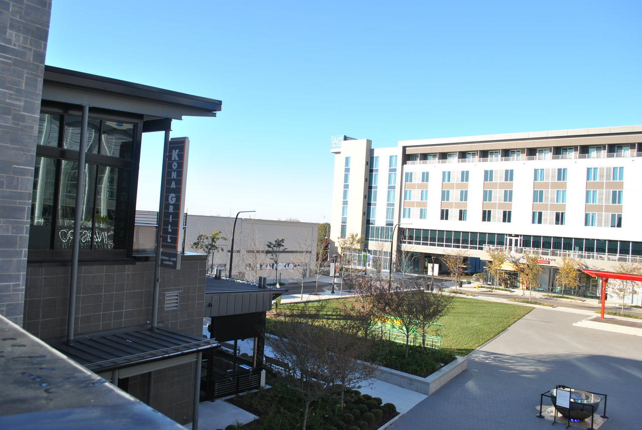 Urban plaza with modern buildings and blue sky.