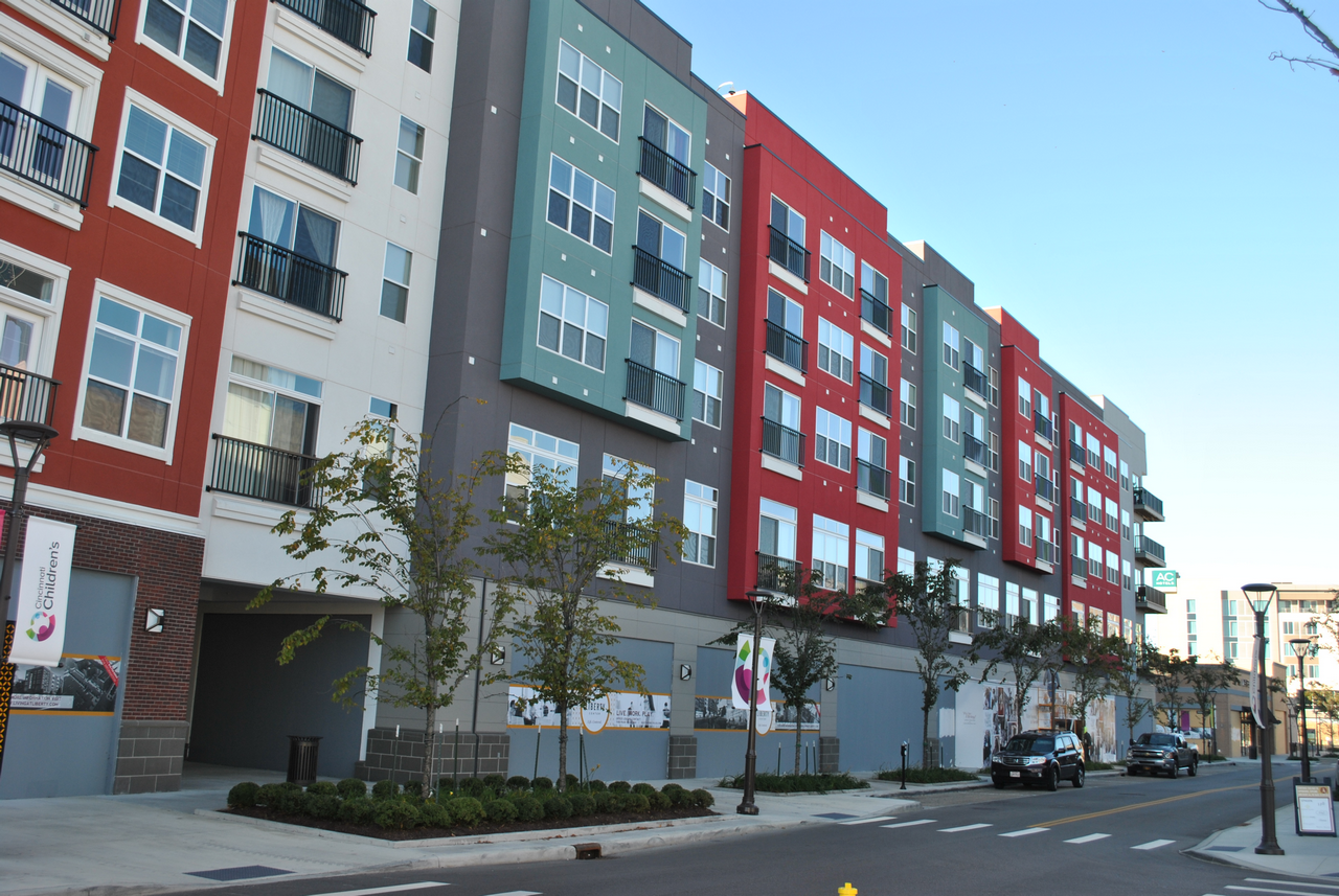 Apartment building with colorful facades along a street.