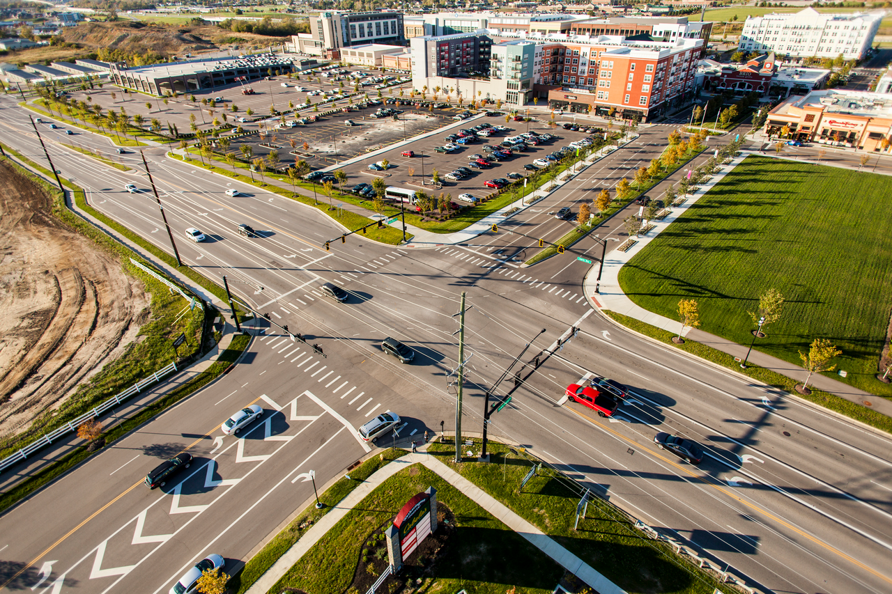 Aerial view of a busy intersection with cars and surrounding buildings.