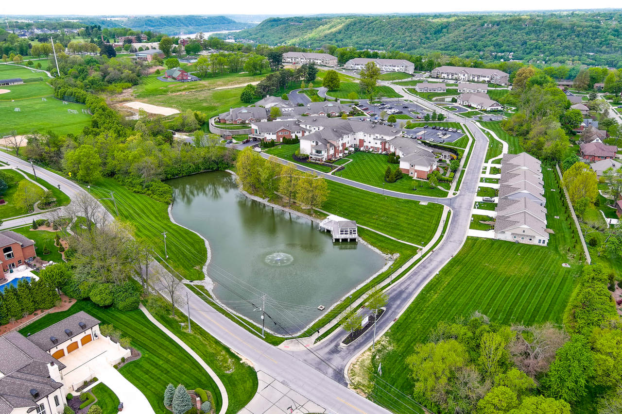 Aerial view of a suburban neighborhood with a central pond.