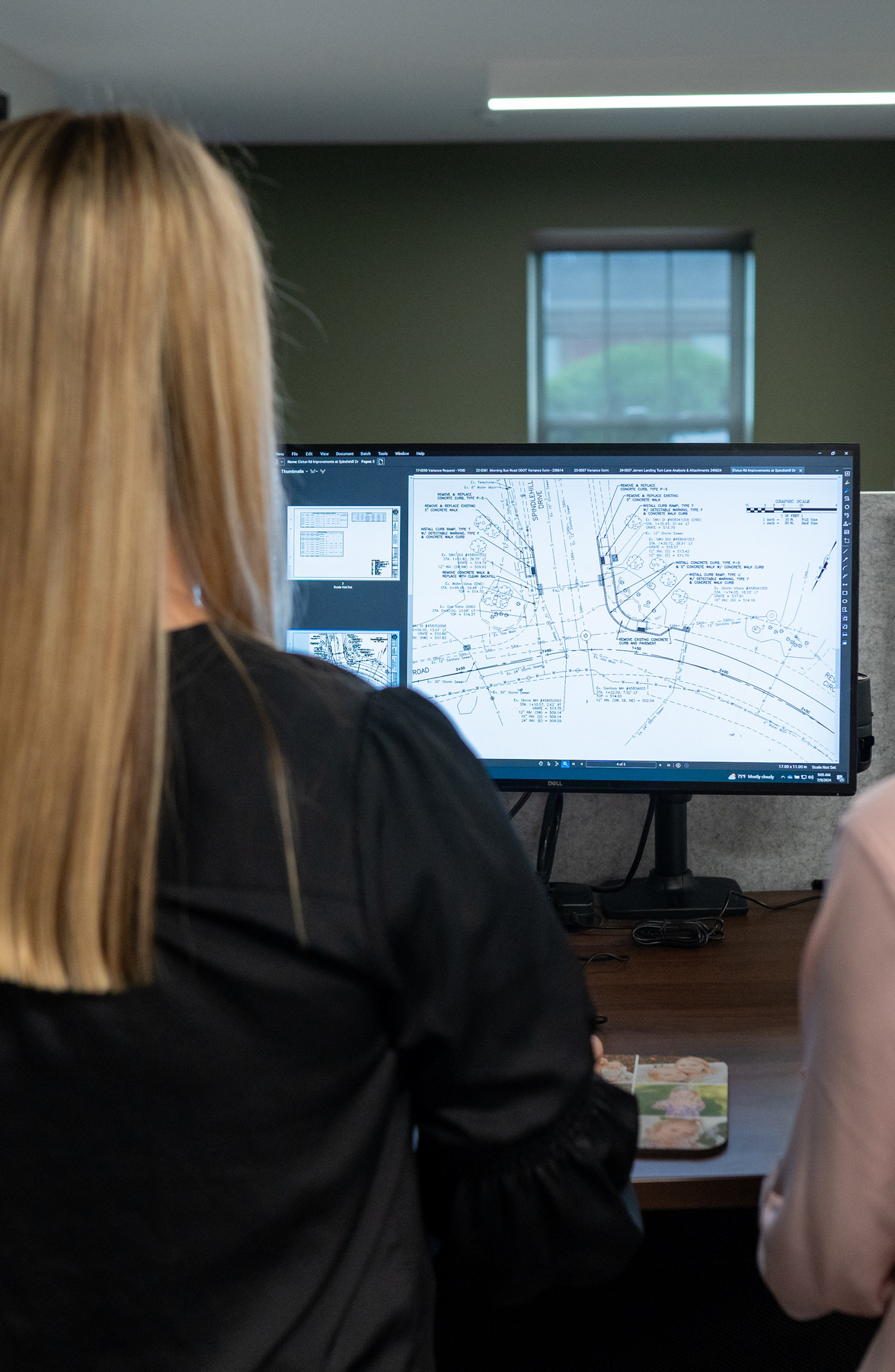 Bayer Becker Transportation Engineering Two people viewing a large computer monitor with diagrams.