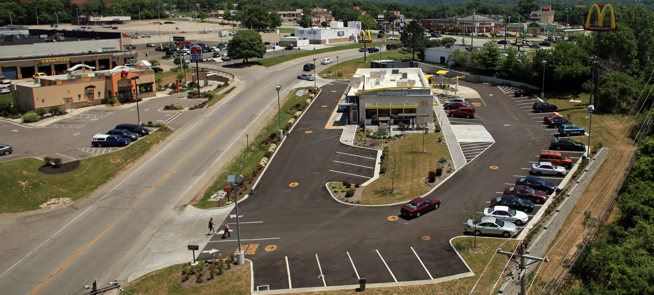 Aerial view of a fast food restaurant with a large parking lot.