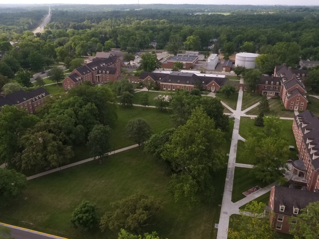 Aerial view of a college campus with green lawns and brick buildings.