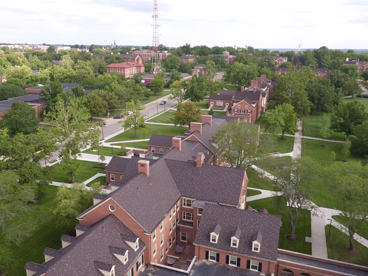 Aerial view of a scenic college campus with brick buildings and green spaces.
