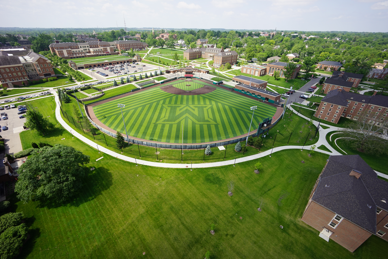 Aerial view of a baseball field and surrounding campus buildings.