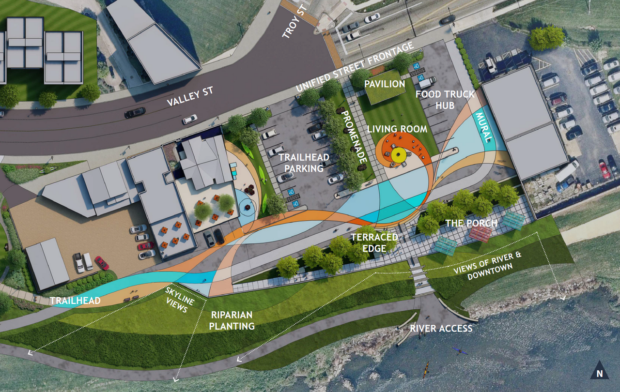 Aerial map of a park with trails, buildings, and a parking lot near a waterway.