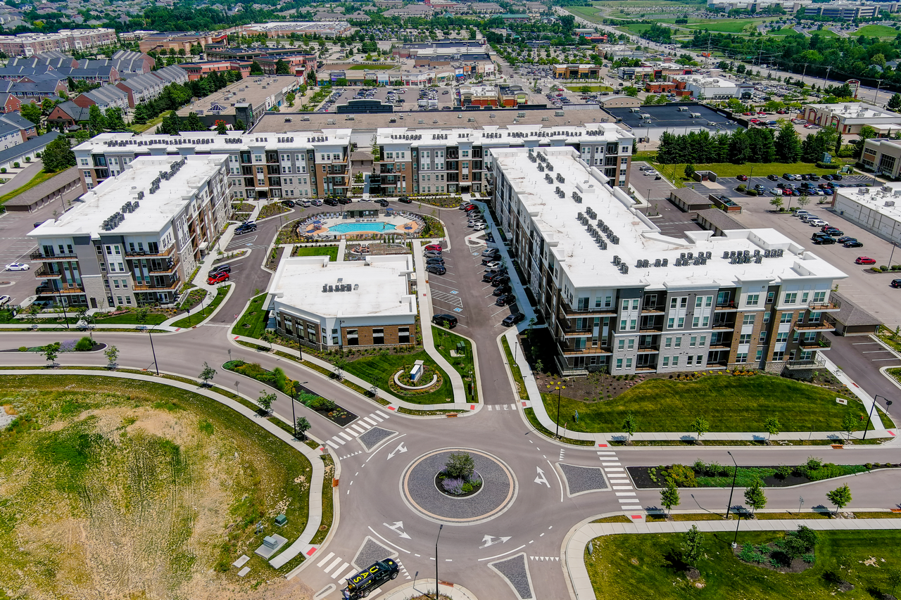 Aerial view of a large apartment complex with a central roundabout.