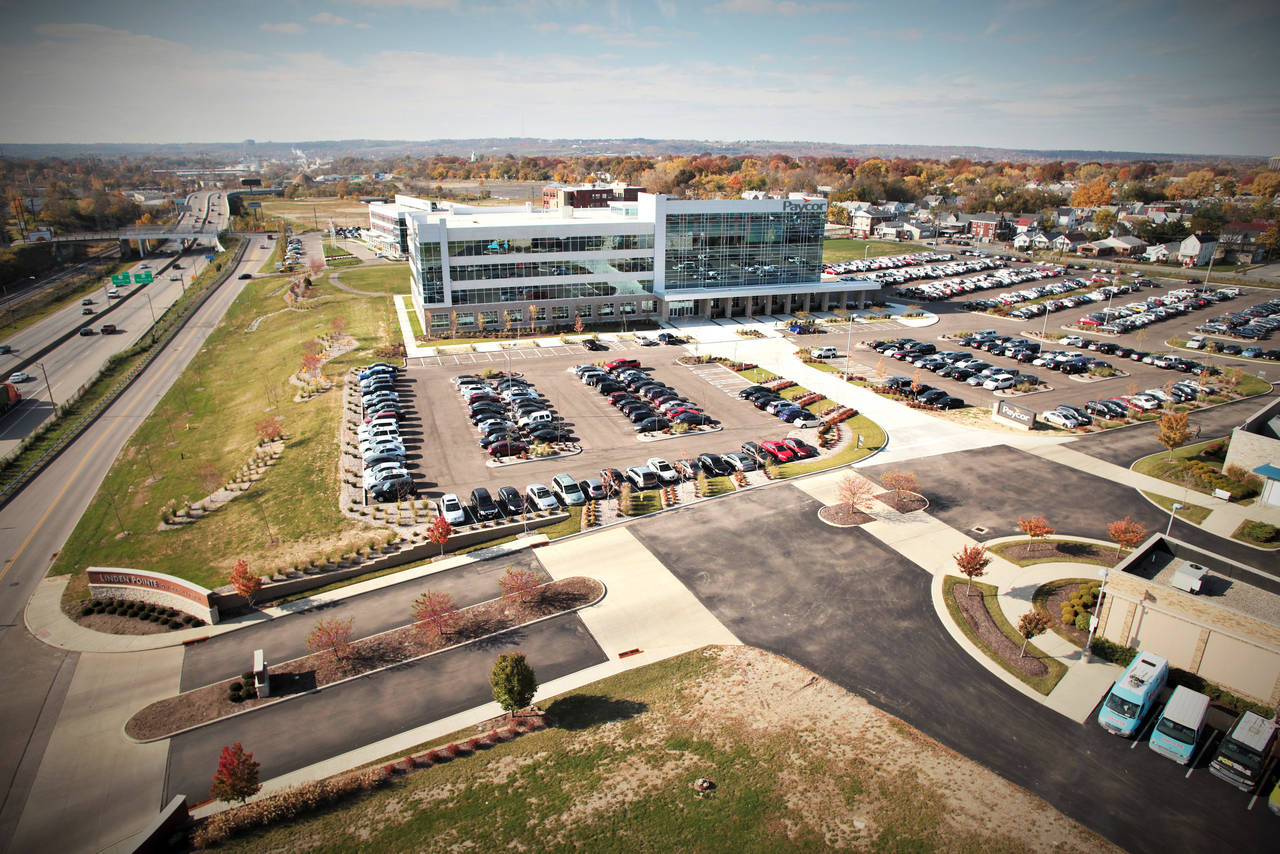 Aerial view of a large office building with parking lots and surrounding roads.