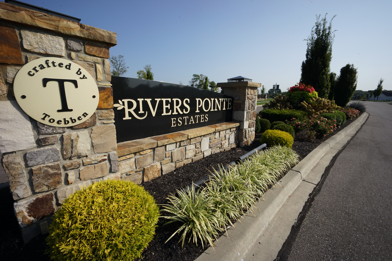 Entrance sign for Rivers Pointe Estates with landscaping.