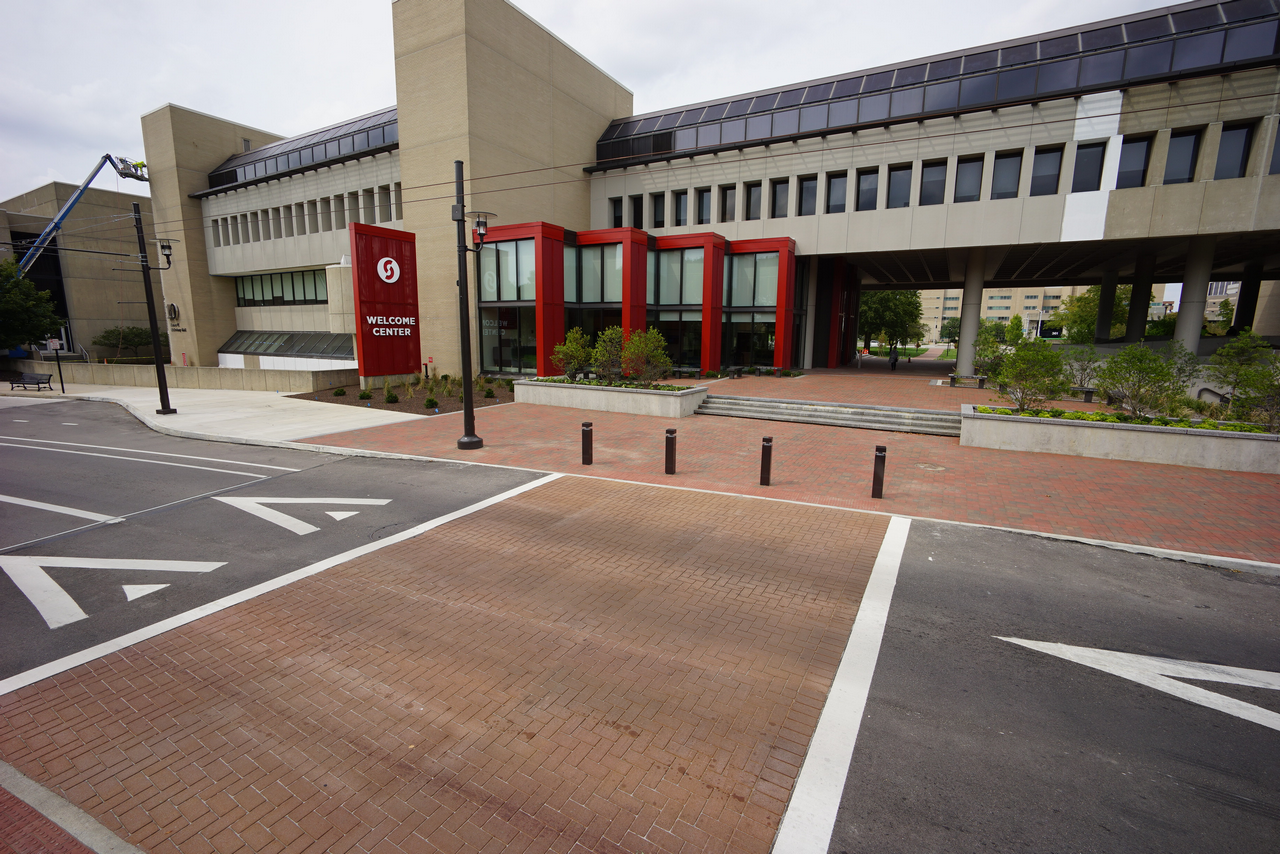 Modern building with red accents and large windows.