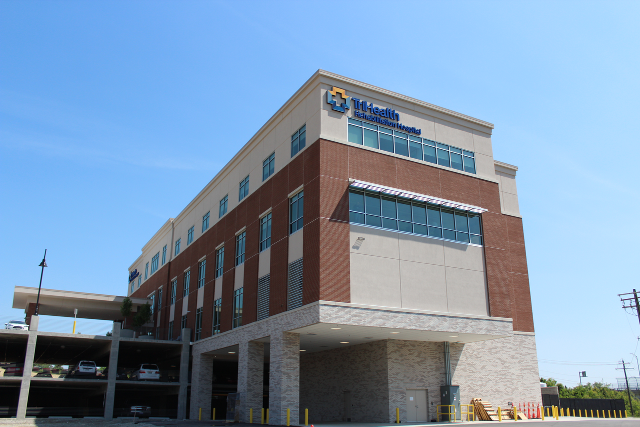Four-story brick building under a clear blue sky.