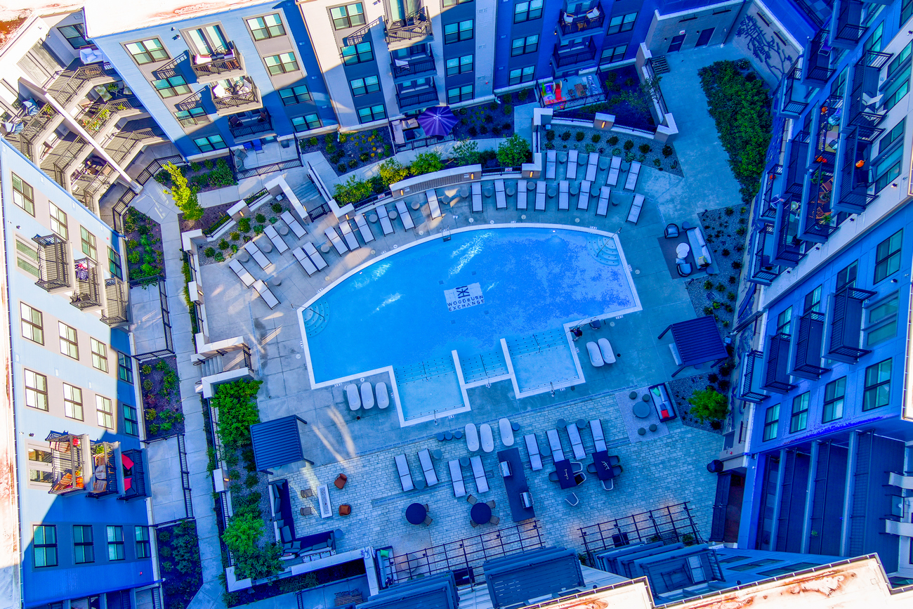 Aerial view of a courtyard pool surrounded by apartment buildings.