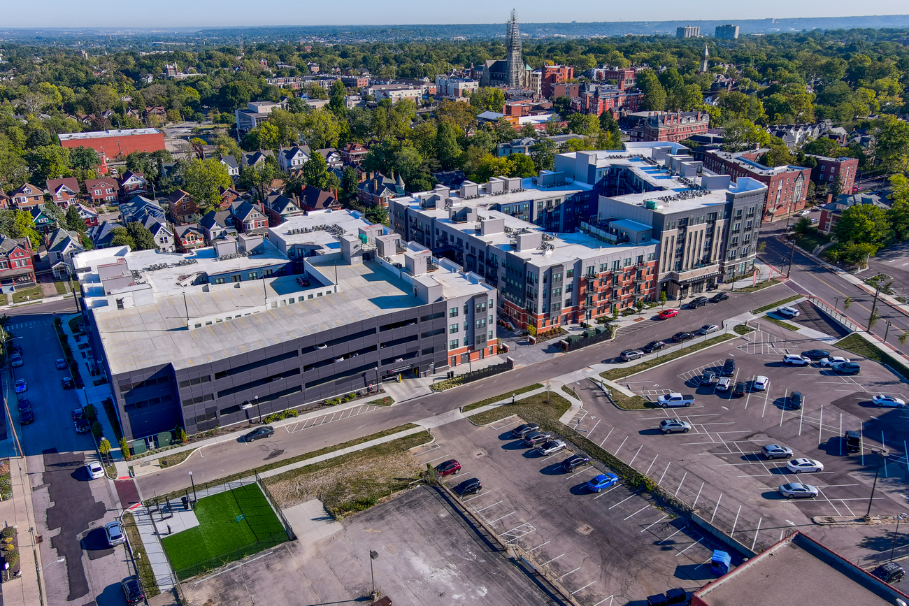 Aerial view of a sprawling urban complex with parking lots and green areas.