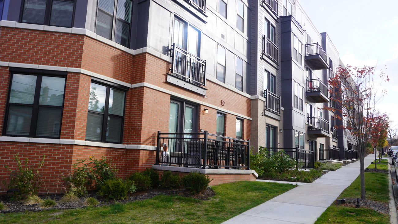Modern apartment building with brick facade and balconies.