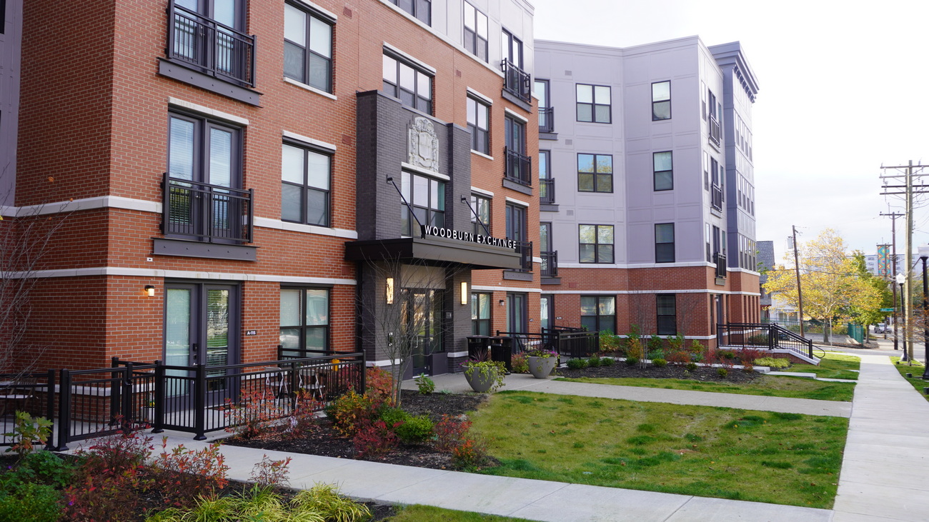 Modern apartment buildings with landscaped front lawns.