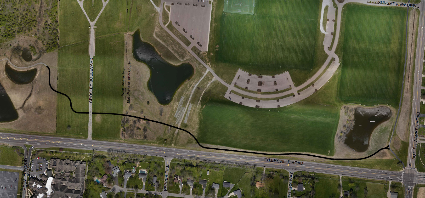 Aerial view of sports fields, parking areas, and a few ponds.