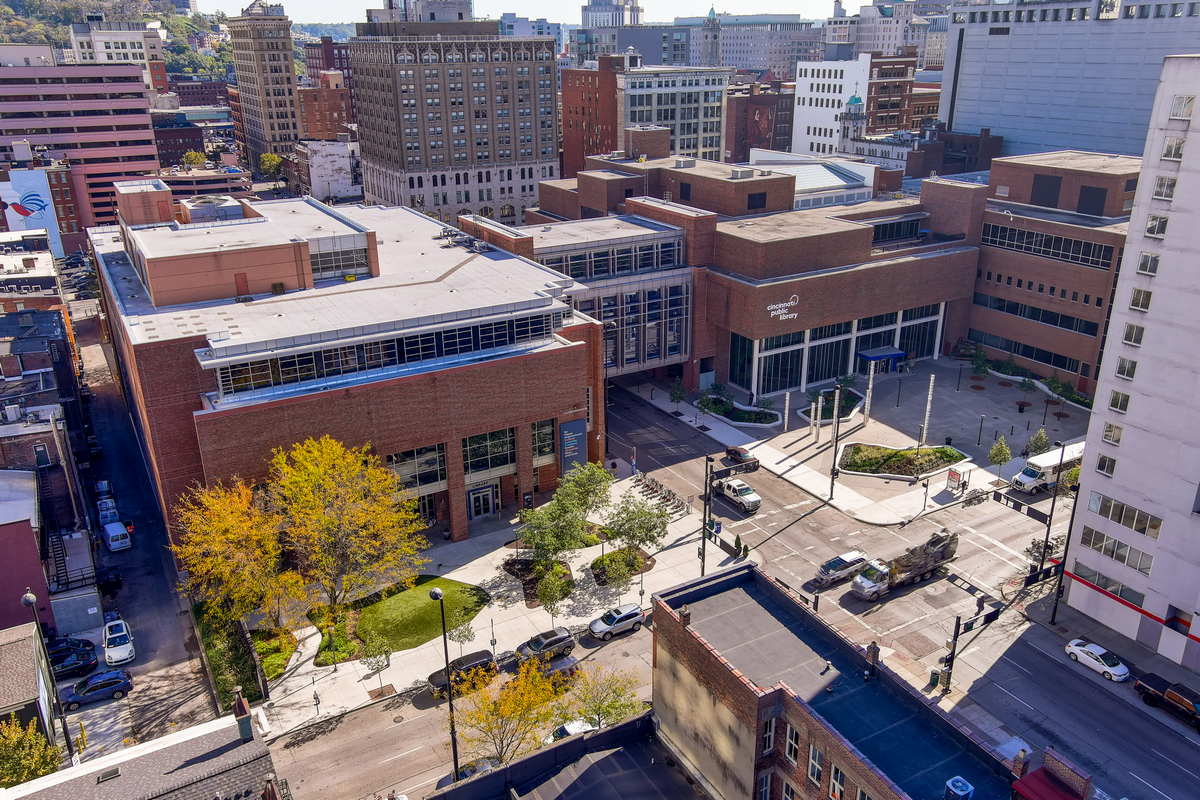 Aerial view of urban buildings and streets with autumn trees.
