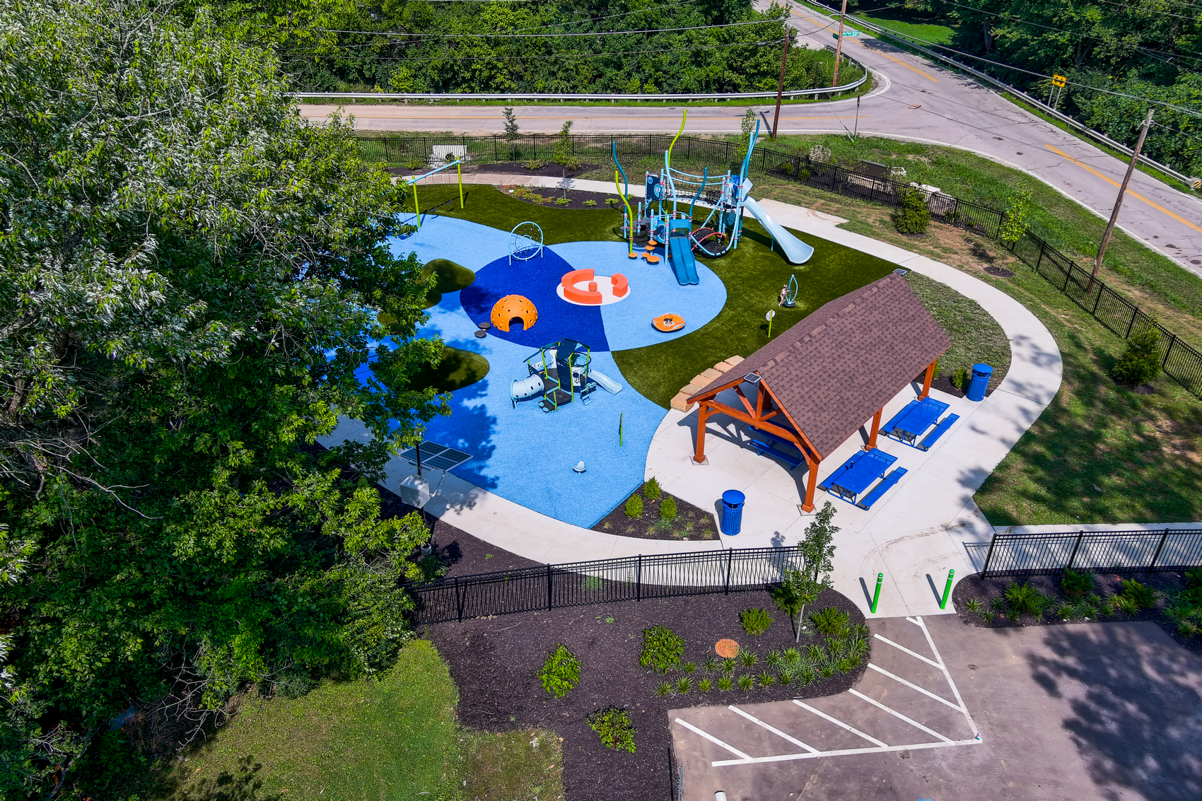 Aerial view of a modern park surrounded by trees.