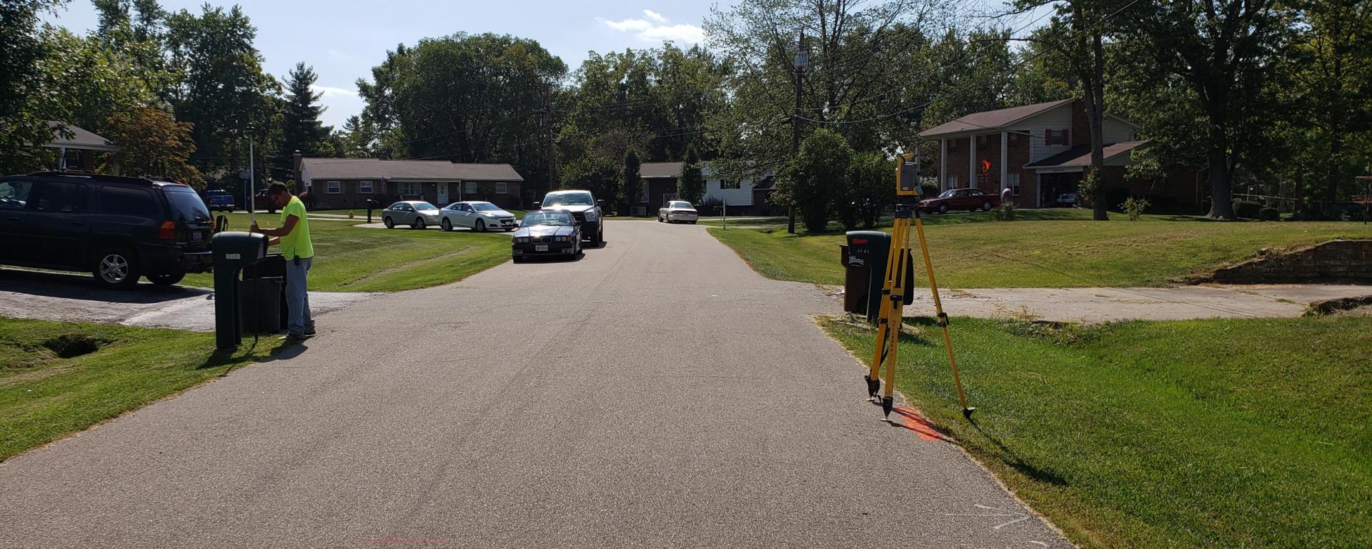 surveying tripod on a neighborhood road