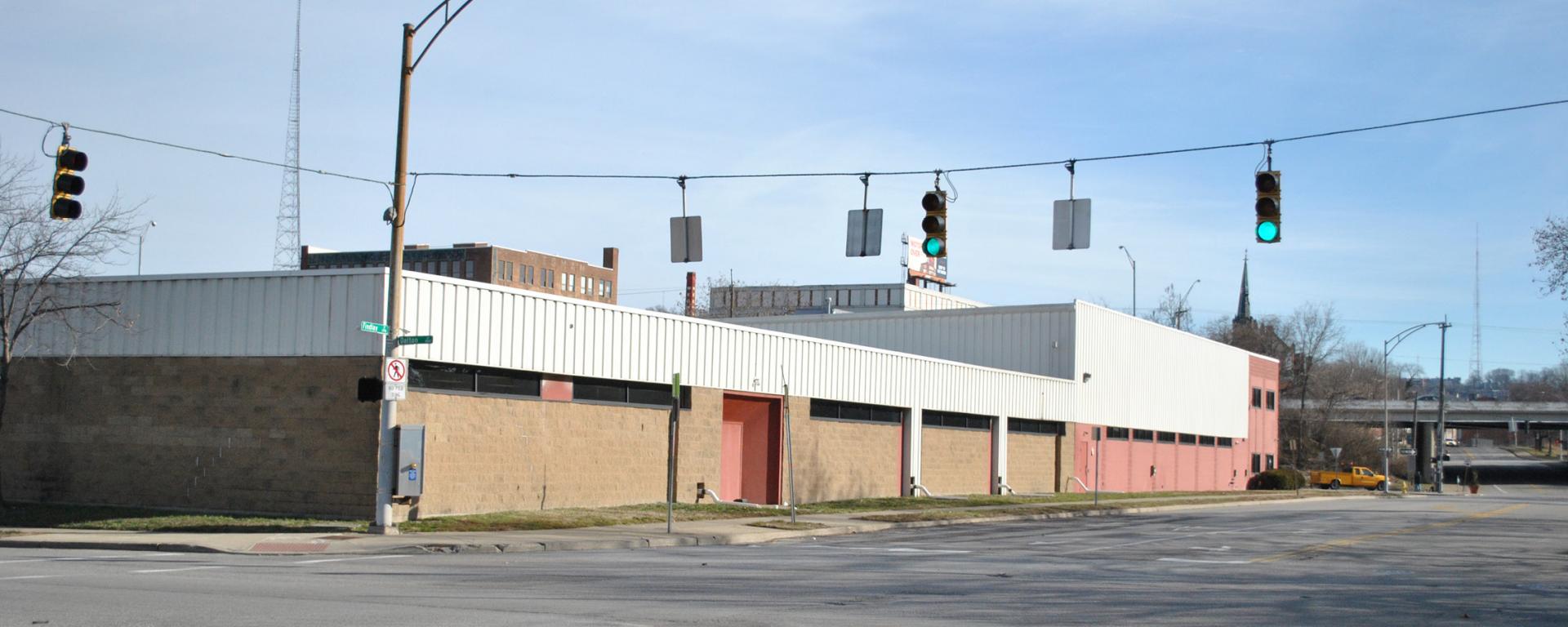 traffic lights hanging across the street from brick building