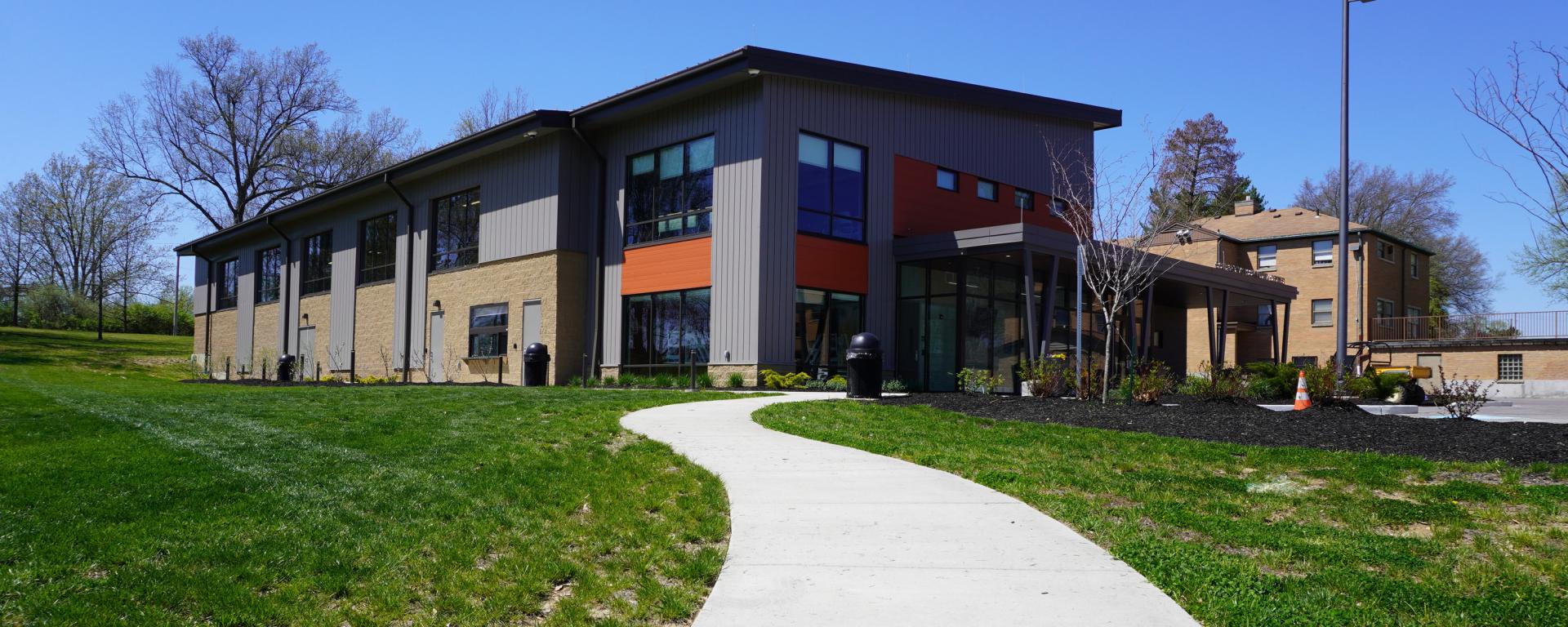 community building with sidewalk winding up to it