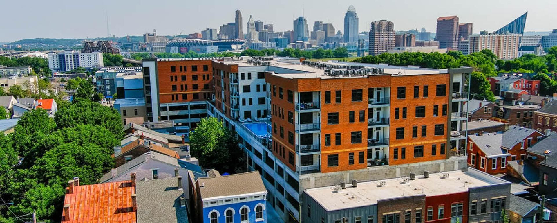 apartment building with city skyline in back