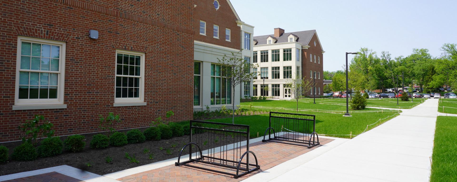 sidewalk leading to red brick building