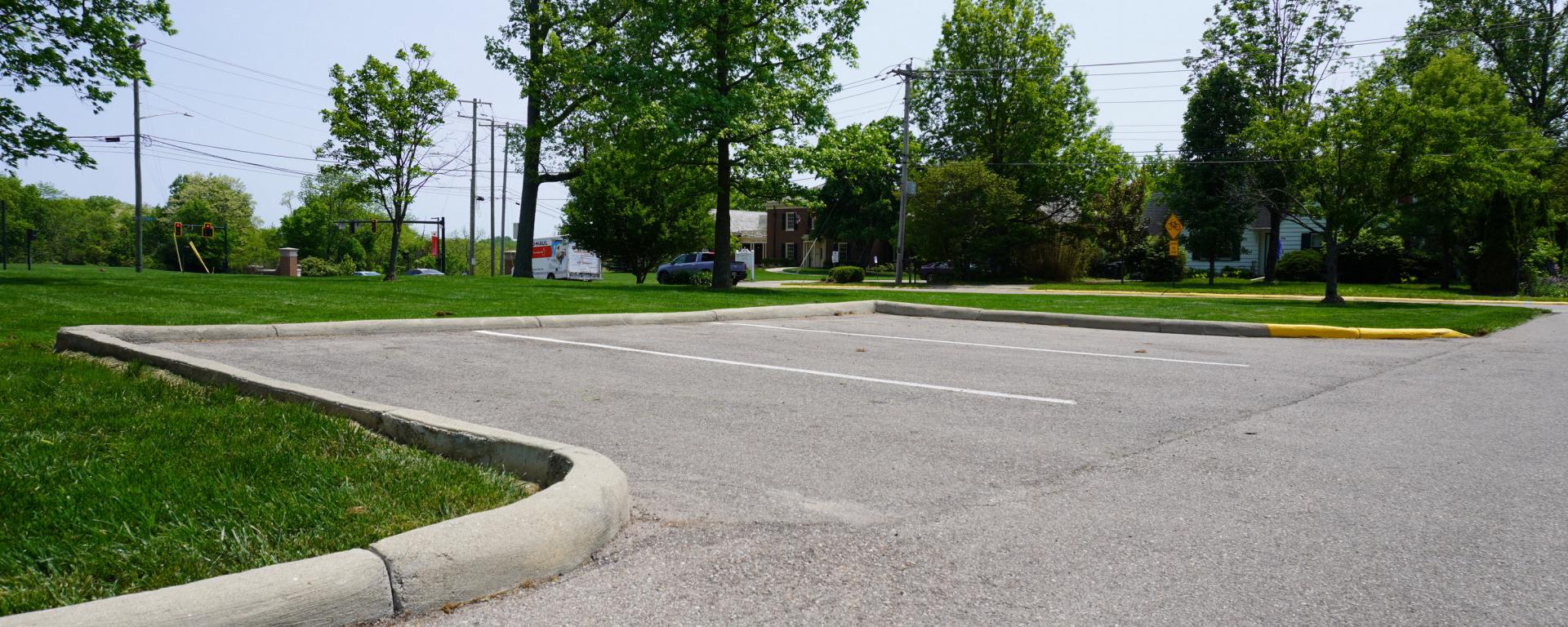 new driveway and small parking lot surrounded by grass