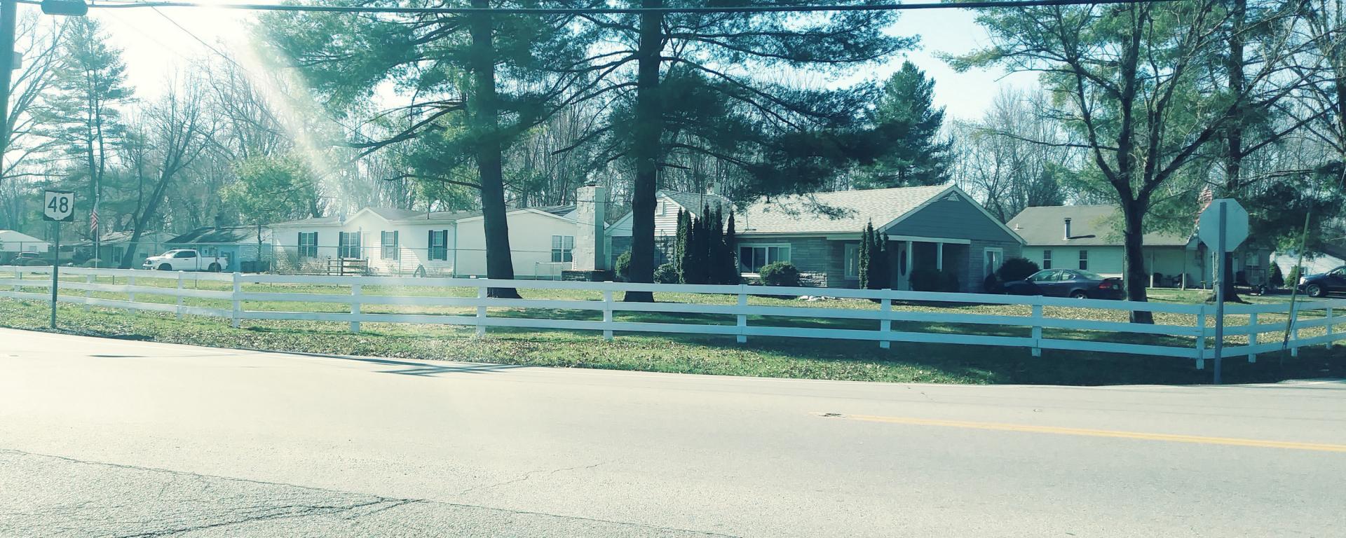 asphalt street with a house on the side