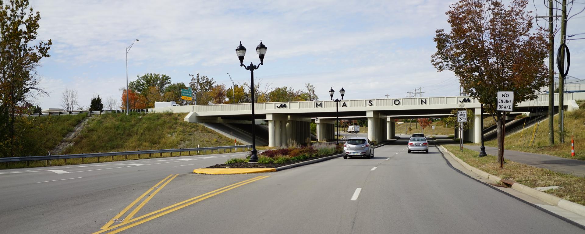 empty roadway with bridge over that reads Mason