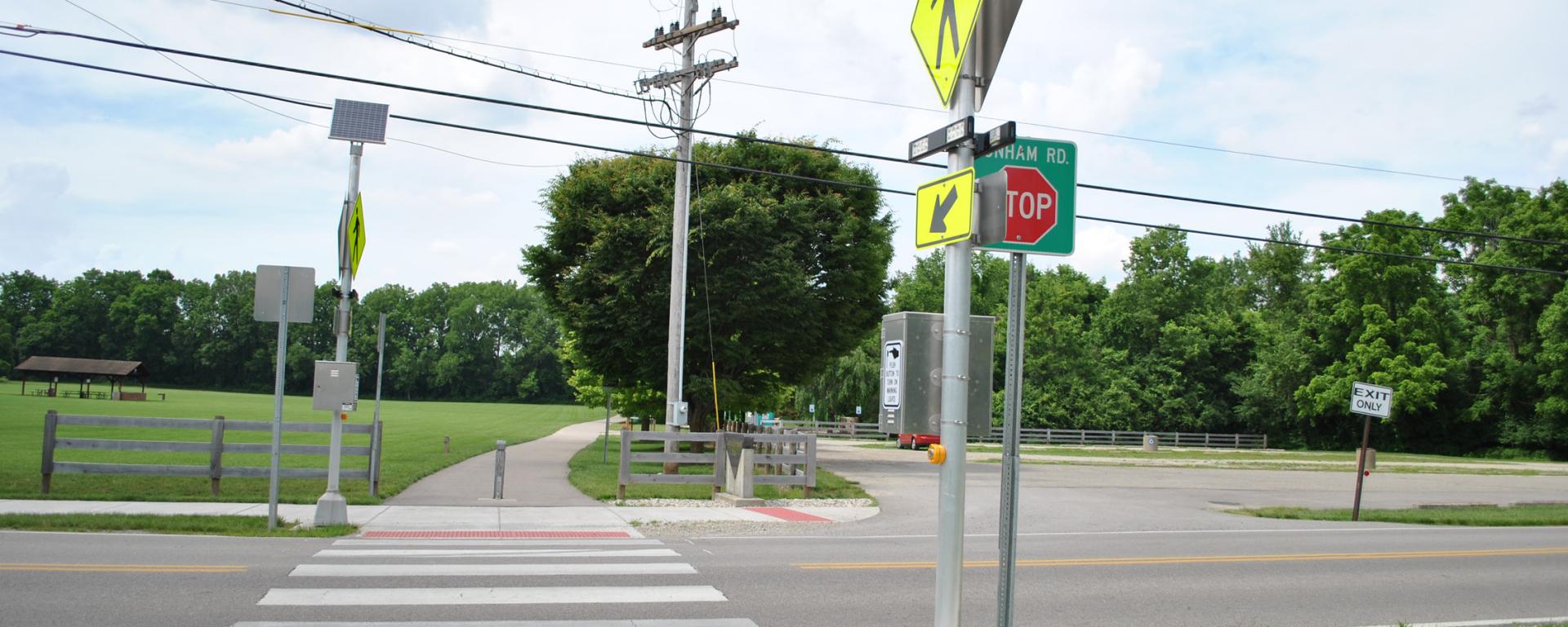 crosswalk with bright yellow sign