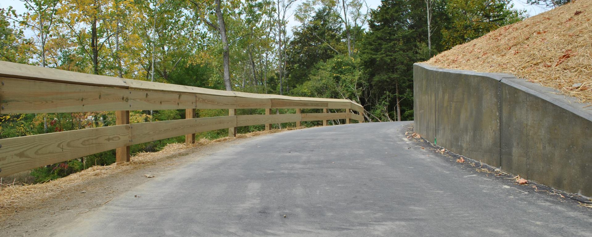 paved trail with wood railing