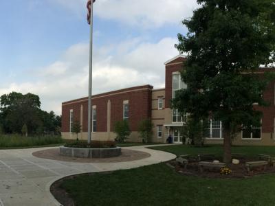 Entryway with flag pole outside of school